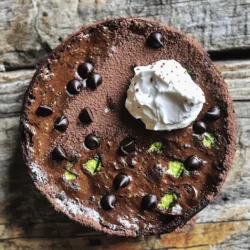 For this Vegan Zucchini Chocolate Cake, you will need: - 1 medium zucchini, grated (about 1 cup) - 1 cup all-purpose flour - 1/2 cup unsweetened cocoa powder - 1 teaspoon baking soda - 1/2 teaspoon baking powder - 1/4 teaspoon salt - 1/2 cup granulated sugar - 1/4 cup vegetable oil - 1/2 cup unsweetened applesauce - 1 teaspoon vanilla extract - 1/2 cup non-dairy milk (almond, soy, or oat) - 1/2 cup dark chocolate chips (dairy-free if necessary) - Optional: 1/4 cup chopped walnuts or pecans for added crunch You can make this cake your own with a few swaps. If you want to avoid sugar, use maple syrup or agave nectar instead. For gluten-free options, substitute the all-purpose flour with a gluten-free blend. You can also use coconut oil in place of vegetable oil for a different flavor. Applesauce can be replaced with mashed banana or even silken tofu for a creamy texture. Zucchini is a fantastic ingredient for baking. It adds moisture without extra fat. This veggie is low in calories, making it a great choice for desserts. Zucchini is rich in vitamins A and C, which are good for your skin and immune system. It also has fiber, which aids digestion. Adding zucchini to your cake not only makes it moist but also sneaks in some healthy nutrients, making your treat a bit more wholesome. Start by setting your oven to 350°F (175°C). This ensures even baking. While the oven heats, grease and flour an 8-inch round cake pan. Alternatively, you can line it with parchment paper. This helps the cake come out smoothly. In a large bowl, add the following dry ingredients: - 1 cup all-purpose flour - 1/2 cup unsweetened cocoa powder - 1 teaspoon baking soda - 1/2 teaspoon baking powder - 1/4 teaspoon salt Whisk these ingredients together until they blend well. This helps distribute the leavening agents evenly. In a separate bowl, mix together: - 1/2 cup granulated sugar - 1/4 cup vegetable oil - 1/2 cup unsweetened applesauce - 1 teaspoon vanilla extract Stir these ingredients until the mixture is smooth and creamy. This step adds moisture and flavor to your cake. Now, gently fold in the grated zucchini and chocolate chips: - 1 medium zucchini, grated (about 1 cup) - 1/2 cup dark chocolate chips This is where the magic happens. The zucchini adds moisture, while the chocolate chips bring sweetness. Mix until everything is combined but do not overmix. Pour the batter into your prepared cake pan. Spread it evenly. Bake the cake in your preheated oven for 25-30 minutes. To check if it’s done, insert a toothpick into the center. If it comes out clean, the cake is ready. Let it cool in the pan for about 10 minutes, then move it to a wire rack. This cooling time helps it finish setting up. For the full recipe, refer to the earlier sections. Enjoy your baking! To keep your vegan zucchini chocolate cake light, avoid overmixing the batter. Mix only until the dry and wet ingredients come together. Overmixing adds air but can make the cake dense. Also, measure your flour correctly. Too much flour can weigh down the cake. Use the scoop and level method: scoop flour into your measuring cup, then level it with a knife. Grating zucchini properly helps keep the cake moist. Use a box grater or a food processor with a grating attachment. Grate the zucchini with the skin on for added nutrients. After grating, squeeze out excess moisture using a clean dish towel. This helps prevent a soggy cake. You want the zucchini to blend well without adding too much water. For even baking, make sure your oven is at the right temperature. An oven thermometer can help if you have doubts. Place the cake pan in the center of the oven. This allows hot air to circulate evenly. Rotate the pan halfway through baking for uniform heat. Check the cake with a toothpick; it should come out clean when it’s done. If you follow these steps, you’ll enjoy a perfectly baked cake. {{image_2}} You can easily make this cake gluten-free. Just swap the all-purpose flour for a gluten-free blend. Look for a mix that includes xanthan gum. This will help your cake rise and stay fluffy. It’s also good to check the labels on all your ingredients to ensure they are gluten-free. To add a fun crunch, include nuts like walnuts or pecans. Just chop them up and fold them into the batter. You can also use seeds like sunflower or pumpkin seeds for a nut-free option. For more flavor, try adding shredded coconut or even dried fruit like raisins or cranberries. Boost the flavor with simple spices or extracts. A half teaspoon of cinnamon adds warmth. You can also include a bit of espresso powder to deepen the chocolate taste. If you like, try adding a splash of almond extract or orange zest for a unique twist. These little changes make the cake even more special. For the Full Recipe, you can find all the steps and ingredients needed to create this delicious vegan zucchini chocolate cake. Explore and enjoy making it your own! To keep your vegan zucchini chocolate cake fresh, store it in an airtight container. This helps maintain moisture and flavor. Place the cake in a cool, dry spot. If you live in a warm area, use the fridge. The cake will stay good for about three to four days. If you cut the cake, cover the exposed parts with plastic wrap to prevent drying. Freezing is a great way to save extra cake. First, let the cake cool completely. Then, slice it into individual pieces. Wrap each slice tightly in plastic wrap, then place them in a freezer bag. Label the bag with the date. You can freeze the cake for up to three months. When you want a slice, simply take it out and let it thaw in the fridge overnight. To reheat your cake, use the microwave for quick results. Heat one slice at a time for about 15-20 seconds. If you prefer a warm cake with a crust, use the oven. Preheat it to 350°F (175°C), wrap the slice in foil, and heat for 10-15 minutes. Enjoy it warm, maybe with a scoop of vegan ice cream! For the full recipe, check out the details above. You can make this cake without zucchini, but it will change the texture. Zucchini adds moisture and keeps the cake soft. If you skip it, the cake may turn out dry. You might try using applesauce or mashed bananas as a substitute. Both keep the cake moist, but the flavor will shift a bit. You can use almond, soy, or oat milk as your non-dairy option. Each brings its own flavor. Almond milk offers a light taste, while soy milk is creamier. Oat milk is also thick and works well in baking. Choose what you like best or what you have on hand. The best way to check if your cake is done is with a toothpick. Insert it into the center of the cake. If it comes out clean, the cake is ready. If it has batter stuck to it, bake for a few more minutes. Keep an eye on it to avoid overbaking. Yes, you can use other sweeteners. Maple syrup or agave nectar work well. Just remember that liquid sweeteners may change the cake's texture. If you use a granulated sweetener like coconut sugar, it should bake similarly to regular sugar. Adjust the amounts as needed for the best taste. Absolutely! This cake is great for kids. The chocolate flavor is rich and hides any veggie taste. Plus, it is a fun way to sneak in some healthy zucchini. Kids often love the sweetness and moist texture. Just make sure they are okay with dark chocolate chips. You can find the full recipe for Vegan Zucchini Chocolate Cake in the previous sections. It lists all the ingredients and steps to whip up this delicious treat. Enjoy the process and happy baking! We explored how to make a tasty zucchini chocolate cake. First, you learned about the key ingredients and their benefits. Then, I shared step-by-step instructions so you can bake with ease. We also discussed helpful tips to ensure your cake turns out light and fluffy. You discovered fun variations to suit your taste, along with smart storage tips. Now, you can enjoy a delicious cake that's perfect for any occasion. With these insights, baking this treat will be simple and fun!