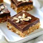 - 1 cup almond butter - 1 cup rolled oats - 1/2 cup honey or maple syrup - 1/2 cup dark chocolate chips - 1/4 cup unsweetened cocoa powder - 1/4 teaspoon salt - 1/2 teaspoon vanilla extract - 1/4 cup sliced almonds (for topping) These ingredients create a tasty and healthy treat. Almond butter gives the bars a creamy texture. Rolled oats add a nice chew. Honey or maple syrup sweetens them naturally. Dark chocolate chips bring rich flavor. Cocoa powder enhances the chocolate taste. Salt balances the sweetness, and vanilla adds warmth. Lastly, sliced almonds provide a crunchy topping. When picking almond butter, choose one without added sugar or oils. This choice keeps the bars wholesome. For oats, use rolled oats, not instant. Instant oats can make the bars too mushy. If you prefer a vegan option, use maple syrup. It works just as well as honey. These ingredients come together to make a simple yet delicious treat. You can find them at any grocery store. - Step 1: Combine wet ingredients in a mixing bowl Start by adding the almond butter, honey or maple syrup, vanilla extract, and salt into a mixing bowl. Mix them well until they form a smooth blend. This step is key for flavor. - Step 2: Incorporate dry ingredients for the dough Now, add the rolled oats and cocoa powder to the wet mix. Stir until everything is evenly combined. You want a thick dough that holds together nicely. - Step 3: Line the baking pan and press the mixture Line an 8x8 inch baking pan with parchment paper. Leave some overhang for easy lifting later. Press the dough into the pan firmly. Make sure it spreads evenly across the bottom. - Step 4: Melt and pour the chocolate In a microwave-safe bowl, melt the dark chocolate chips. Do this in 30-second intervals. Stir in between until smooth. Once melted, pour it over the pressed mixture in the pan. Spread it out evenly with a spatula. - Step 5: Add toppings and refrigerate While the chocolate is warm, sprinkle the sliced almonds on top. Gently press them into the chocolate. Now, place the pan in the fridge for at least 2 hours to set. After that, you can lift the bars out and cut them into squares. Enjoy your tasty creation! - Use fresh almond butter for better flavor. Fresh almond butter has a rich taste that enhances the bars. - Ensure even packing of the mixture. Press the mix firmly into the pan. A well-packed bar holds together better. - Customize your chocolate melting method. You can melt it in the microwave or on the stove. Both methods work well, but be careful not to burn the chocolate. - For presentation, serve bars on a sleek platter. Drizzle extra melted chocolate on top for flair. A sprinkle of sea salt adds a nice touch too. - Pair these bars with a cold glass of milk or a warm cup of coffee. The flavors work well together and make a perfect snack. {{image_2}} You can change the flavor of these bars easily. Instead of almond butter, try using peanut butter. It gives a nice twist. You can also use sunflower seed butter if you want a nut-free option. Both will work well. For sweeteners, you can switch from honey to agave syrup. Date syrup is another great choice. Each sweetener adds a different taste. Experiment to find your favorite! Want to make your bars more fun? Add in some dried fruits like raisins or cranberries. These add sweetness and chewiness. You can also throw in seeds like chia or flax. They boost nutrition and give a nice crunch. If you love nuts, try different kinds. Chopped walnuts or pecans can add a new flavor. You can also use mixed nuts for a surprise in every bite. Each variation makes your bars unique and tasty! Store your No-Bake Chocolate Almond Butter Bars in an airtight container. Glass or plastic containers work well. You can also use a resealable bag if you can't find a container. These bars need a cool spot. You can keep them at room temperature for a few hours. For longer storage, put them in the fridge. This keeps them firm and fresh. These bars last about one week in the fridge. If you store them at room temperature, they stay good for about three days. Look for signs of spoilage. If the bars smell off or change color, it’s time to toss them. If they feel sticky or soft, they may not taste as good. Enjoy them while fresh for the best flavor! Yes, you can make these bars vegan. Use maple syrup instead of honey. Ensure the dark chocolate chips are dairy-free. Most brands offer vegan options, so check the label. This way, you keep the bars tasty and suitable for a vegan diet. To make the bars gluten-free, use certified gluten-free rolled oats. Many oats may have traces of gluten from processing. Always check the packaging to avoid cross-contamination. This simple swap ensures everyone can enjoy these yummy treats. You can freeze these bars easily. Once cut, wrap each piece in plastic wrap or foil. Place them in a freezer-safe container. They stay fresh for up to three months. When you're ready to eat, thaw them in the fridge for a few hours. These no-bake chocolate almond butter bars are simple and fun to make. We covered all the key steps, from mixing ingredients to storage tips. You can customize them too, swapping nut butters and sweeteners. Try adding your favorite toppings for a personal touch. With these easy recipes and tips, you’ll create tasty bars that everyone will love. Enjoy your tasty treat and have fun experimenting!