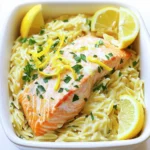 - 1 cup orzo pasta - 2 fillets of salmon (about 6 oz each) - 4 cloves garlic, minced - Zest and juice of 1 large lemon - 2 tablespoons olive oil - 1 cup vegetable or chicken broth - 1/2 cup heavy cream - 1/2 cup grated Parmesan cheese - Salt and pepper to taste - Fresh parsley, chopped, for garnish - Lemon wedges, for serving This dish shines with its fresh flavors and creamy texture. The orzo pasta gives a nice bite, while the salmon adds richness. The garlic and lemon bring bright notes that lift the entire meal. Each ingredient plays a key role in creating a delicious balance. Using high-quality salmon will enhance the dish. Fresh garlic gives a punch of flavor. Zesty lemon adds a refreshing touch. Olive oil helps to bring everything together smoothly. Broth provides depth, while heavy cream adds that luxurious creaminess we all love. Parmesan cheese melts into the sauce, making it even better. When you serve this dish, the fresh parsley and lemon wedges make it look inviting. They also add a pop of color and flavor. Enjoy cooking and savoring this creamy lemon garlic orzo with salmon! - Preheat the oven to 400°F (200°C). - Season both sides of the salmon fillets with salt and pepper. Place them on a lined baking sheet. Bake for 12-15 minutes until cooked through and flaky. This method ensures your salmon is tender and flavorful. - In a pot, bring salted water to a boil. - Add 1 cup of orzo pasta and cook for about 8-10 minutes until al dente. Drain and set aside. This timing helps keep the orzo firm and prevents mushiness. - In a large skillet, heat 2 tablespoons of olive oil over medium heat. - Add 4 cloves of minced garlic and sauté for about 30 seconds. This step releases a wonderful aroma and flavor. - Stir in the zest and juice of 1 large lemon, along with 1 cup of vegetable or chicken broth and ½ cup of heavy cream. Bring to a gentle simmer. Let it cook for 3-4 minutes to let the flavors meld together. - Stir in ½ cup of grated Parmesan cheese until it melts and becomes creamy. - Add the cooked orzo to the skillet, mixing until well combined. The orzo should be fully coated with the sauce. This makes every bite rich and delicious. - Flake the baked salmon into bite-sized pieces. - Gently fold the salmon into the orzo mixture. Adjust seasoning with more salt and pepper as needed. This ensures every bite has the perfect flavors. - Divide the creamy lemon garlic orzo into bowls. - Garnish with fresh parsley and serve with lemon wedges on the side. This adds a fresh touch and a pop of color to your dish. To adjust the creaminess of your orzo dish, you can add more heavy cream. Start with small amounts, mixing it in slowly. If you want a lighter dish, you can use Greek yogurt or sour cream. Both options add tang and creaminess without being too heavy. Baking the salmon gives it a nice, even cook. I like to bake at 400°F (200°C) for 12-15 minutes. If you prefer crispy skin, try pan-searing instead. You can heat oil in a skillet and cook the salmon skin-side down for about 4-5 minutes. Check for doneness by gently flaking the fish with a fork. It should be opaque and flake easily. To avoid mushy orzo, cook it until it is al dente. This means it should have a slight bite to it. Make sure to use a large pot with plenty of water for cooking. When draining, do not rinse the orzo. This helps the sauce stick better. {{image_2}} You can easily make this dish vegetarian. Simply swap the salmon with chickpeas or tofu. Both options give you protein and texture. For added flavor, try marinating your tofu in some lemon juice and garlic before cooking. Adding vegetables is simple too. Toss in spinach, peas, or sun-dried tomatoes while making the sauce. They add color and taste to your orzo. You can also use a mix of seasonal veggies for a fresh twist. Want to jazz up your dish? Consider adding herbs like basil, dill, or thyme. They pair wonderfully with lemon and garlic. You can also sprinkle in some black pepper or smoked paprika for a deeper flavor. Different cheese options can change the taste too. Try feta for a tangy twist or goat cheese for creaminess. Each cheese adds a unique touch to your creamy orzo. If you like some heat, add chili flakes while cooking the sauce. Start with a pinch and taste as you go. You can always add more if you like it hot! Incorporating jalapeños is another option. Chop them finely and sauté with garlic at the start. This adds a fresh, spicy kick to your dish. Adjust the amount to match your spice tolerance. To keep your creamy lemon garlic orzo with salmon fresh, store it in an airtight container. Place it in the fridge right after the meal. This helps maintain its flavor and texture. You can safely store it for 3-4 days. After this, the quality may decline. When you want to enjoy your leftovers, the best way is to use the stove. Heat a pan over low heat. Add a splash of broth or water to keep it moist. Stir often until warmed through. This method helps avoid sogginess. You can also use the microwave, but stir every minute to ensure even heat. To freeze your dish, let it cool completely first. Then, scoop portions into freezer-safe bags or containers. Make sure to remove as much air as possible. This helps prevent freezer burn. You can freeze it for up to 2 months. When ready to eat, thaw it overnight in the fridge. Reheat gently on the stove, adding a bit of cream or broth for creaminess. Yes, you can use whole wheat orzo. It adds a nutty flavor and extra fiber. Just note, it may cook a bit longer than regular orzo. Check the package for timing. You can use Pecorino Romano or nutritional yeast for a dairy-free option. Both add a rich, cheesy flavor. If you prefer, try cream cheese for a creamy texture. Salmon is cooked when it flakes easily with a fork and is opaque. It should reach an internal temperature of 145°F (63°C). Keep an eye on it to avoid overcooking. Yes, you can prepare the orzo and sauce ahead. Store them separately in the fridge. Add the salmon when you’re ready to serve. This keeps everything fresh and tasty. Yes, look for gluten-free orzo made from rice or quinoa. Many brands offer great taste and texture. Always check the label to ensure it's gluten-free. This dish combines orzo, salmon, and a creamy sauce for great flavor. We explored each ingredient, including easy steps to prepare and serve it. I shared tips for perfect creaminess and ways to add spice. You can adjust the recipe for vegetarian options or try different cheeses. Now, you can enjoy this meal often, whether fresh or with leftovers. Remember to store and reheat properly for the best taste. Enjoy your cooking journey!